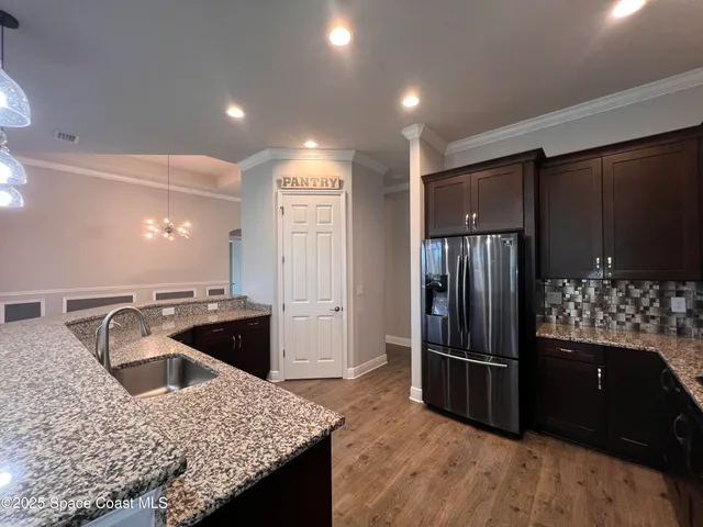 a kitchen with granite countertop a refrigerator and a stove