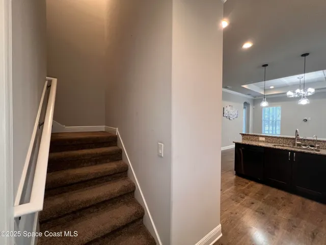a view of entryway and hall with wooden floor