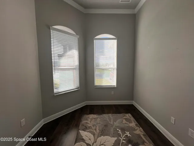 a view of a room with wooden floor and window