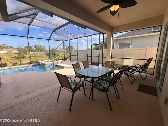 a view of a patio with table and chairs