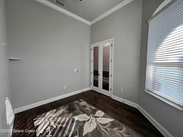 a view of a bedroom with wooden floor
