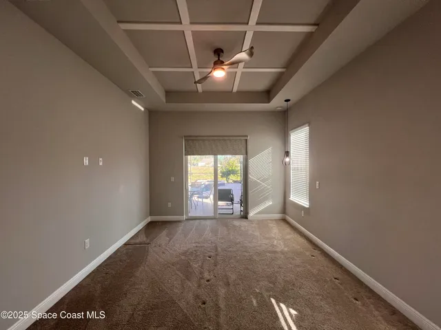 a view of a livingroom with a ceiling fan and window