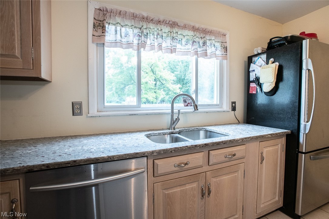 20873 Drake Road Strongsville, OH 44149 - Photo 12 of 25 Kitchen featuring plenty of natural light, stainless steel appliances, and light stone countertops