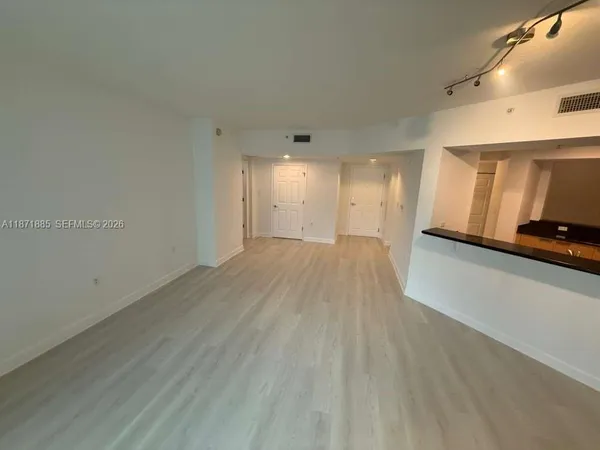 a view of a room with wooden floor