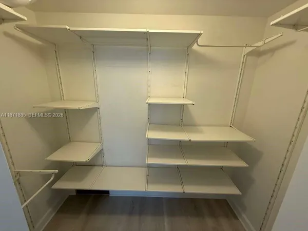 a view of walk in closet with empty racks