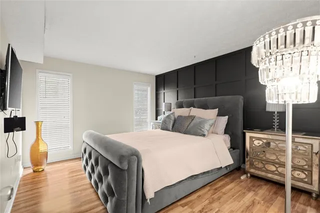 a bedroom with a bed and wooden floor