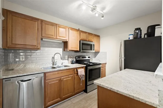 a kitchen with a refrigerator a sink and a refrigerator