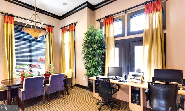 a view of a livingroom with workspace and a window