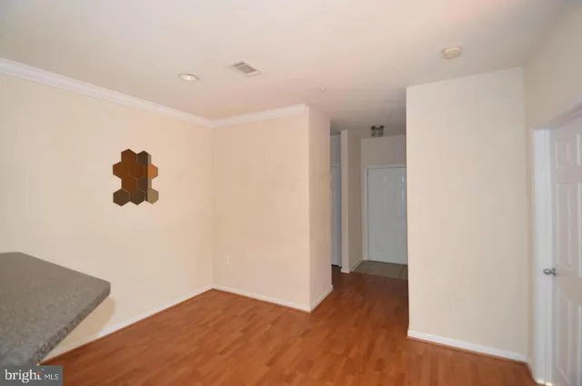 a view of hallway with wooden floor