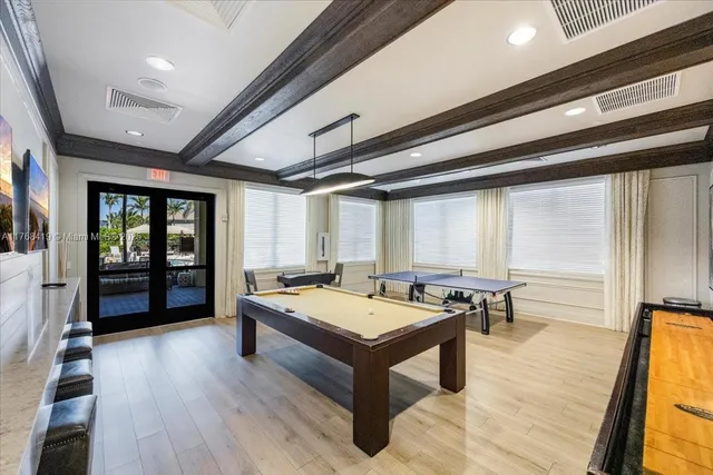 a living room with stainless steel appliances granite countertop furniture wooden floor and next to a window