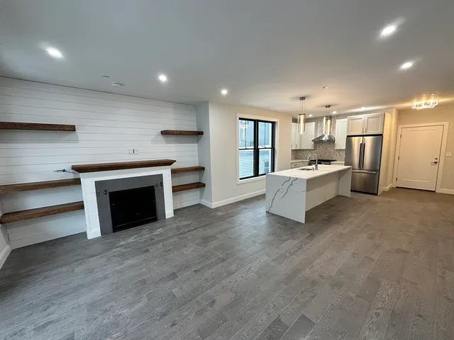 a large white kitchen with a stove top oven a sink and dishwasher
