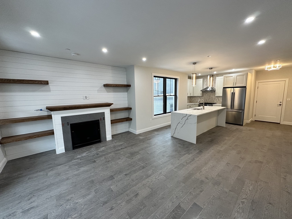 197 Condor Street, Unit 4 Boston, MA 02128 - Photo 1 of 14 a large white kitchen with a stove top oven a sink and dishwasher