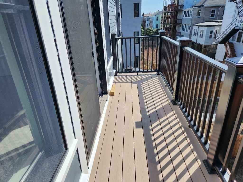 197 Condor Street, Unit 4 Boston, MA 02128 - Photo 5 of 14 a view of balcony with wooden floor