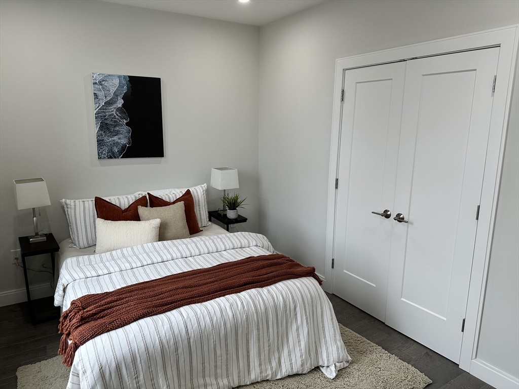 197 Condor Street, Unit 4 Boston, MA 02128 - Photo 6 of 14 a bedroom with a bed and a painting on the wall