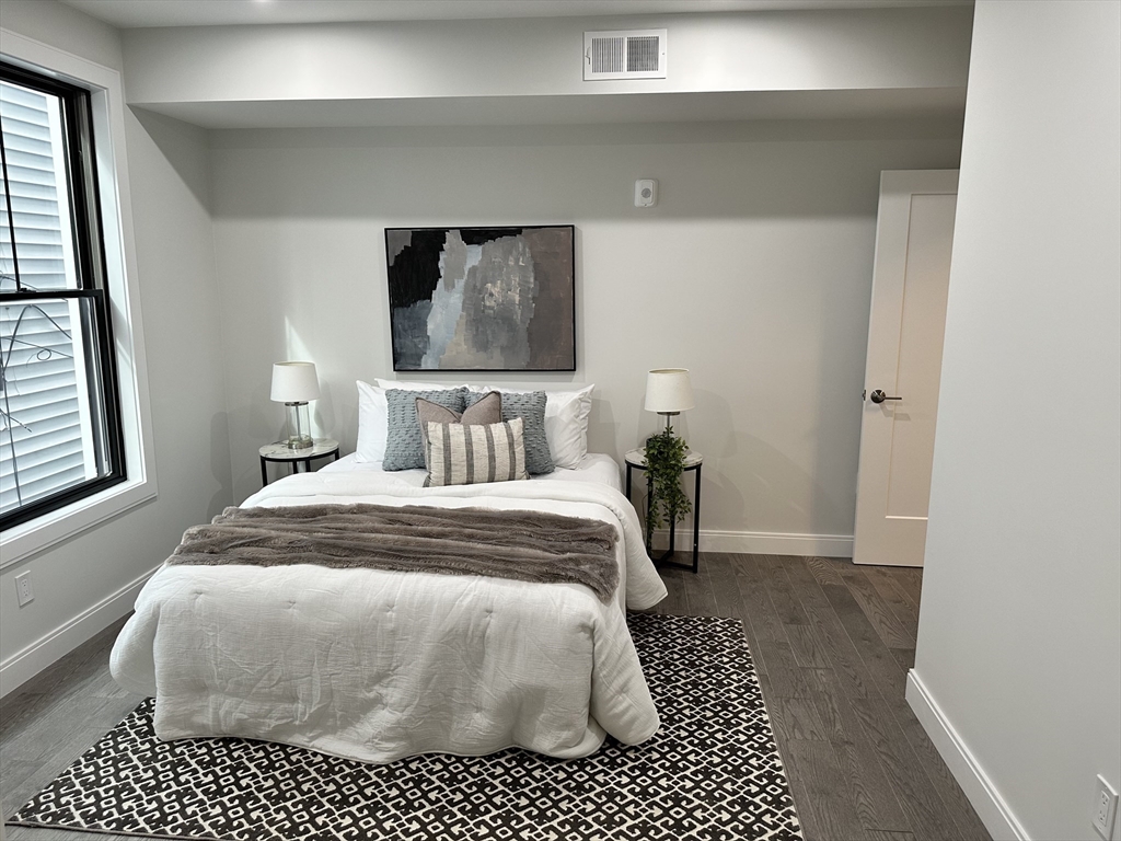 197 Condor Street, Unit 4 Boston, MA 02128 - Photo 8 of 14 a bedroom with a bed and a window
