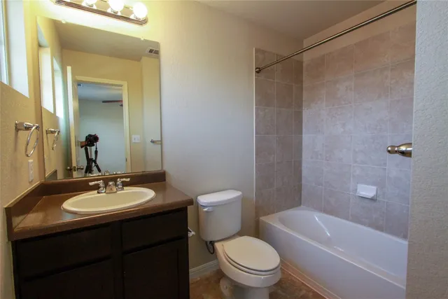 a bathroom with a sink a toilet and a mirror