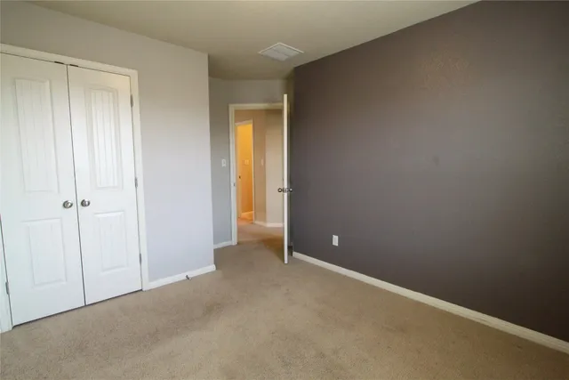an empty room with closet area