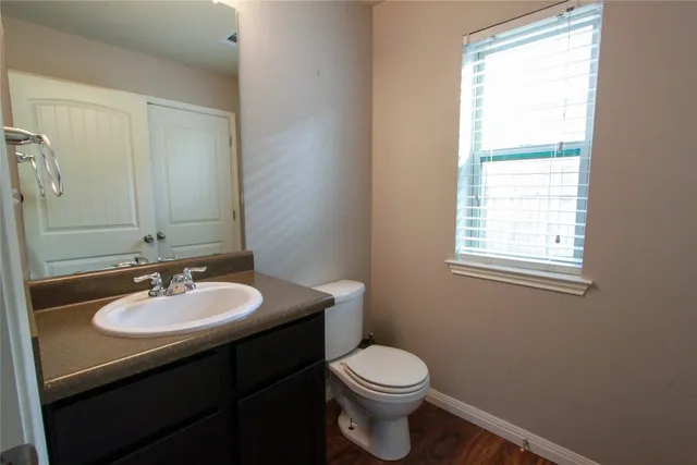 a bathroom with a sink a toilet and mirror