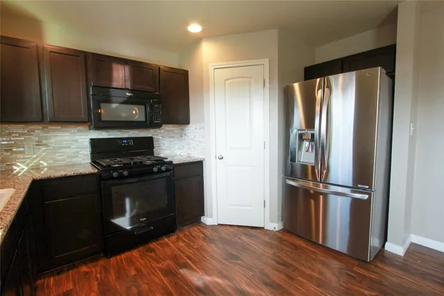 a kitchen with stainless steel appliances wooden cabinets and granite counter tops