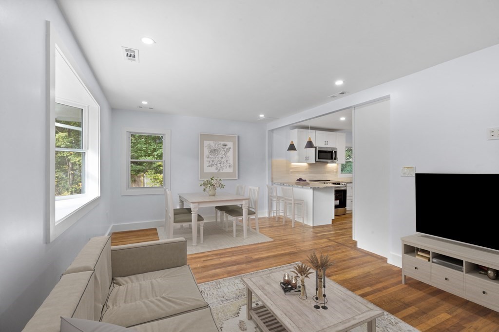 256 Great Road Maynard, MA 01754 - Photo 11 of 26 a living room with furniture and a flat screen tv