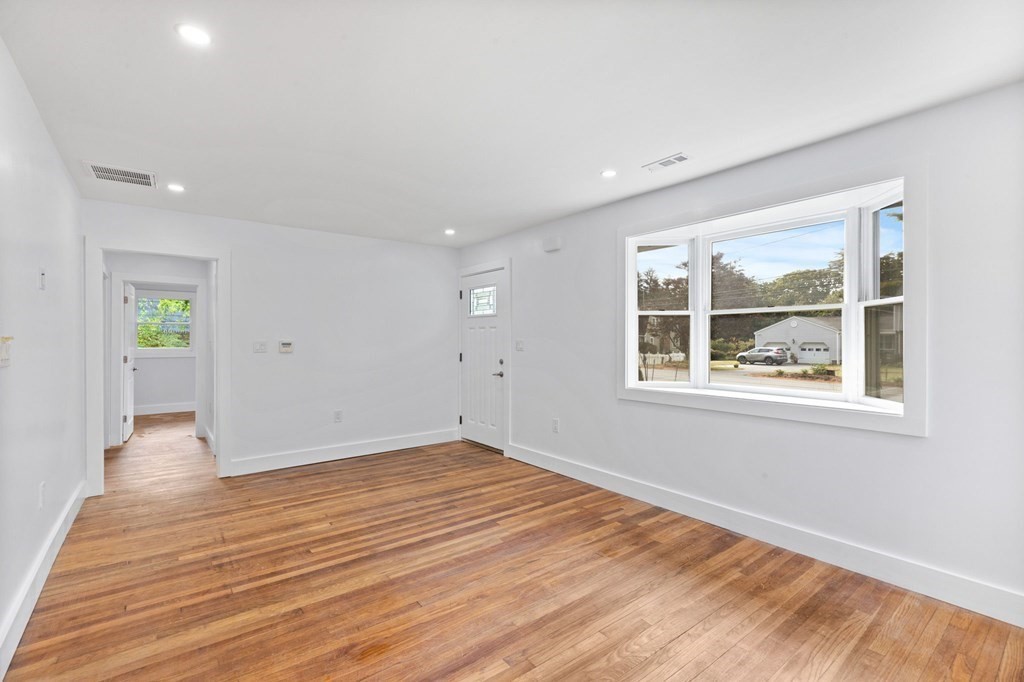 256 Great Road Maynard, MA 01754 - Photo 12 of 26 wooden floor in an empty room with a window