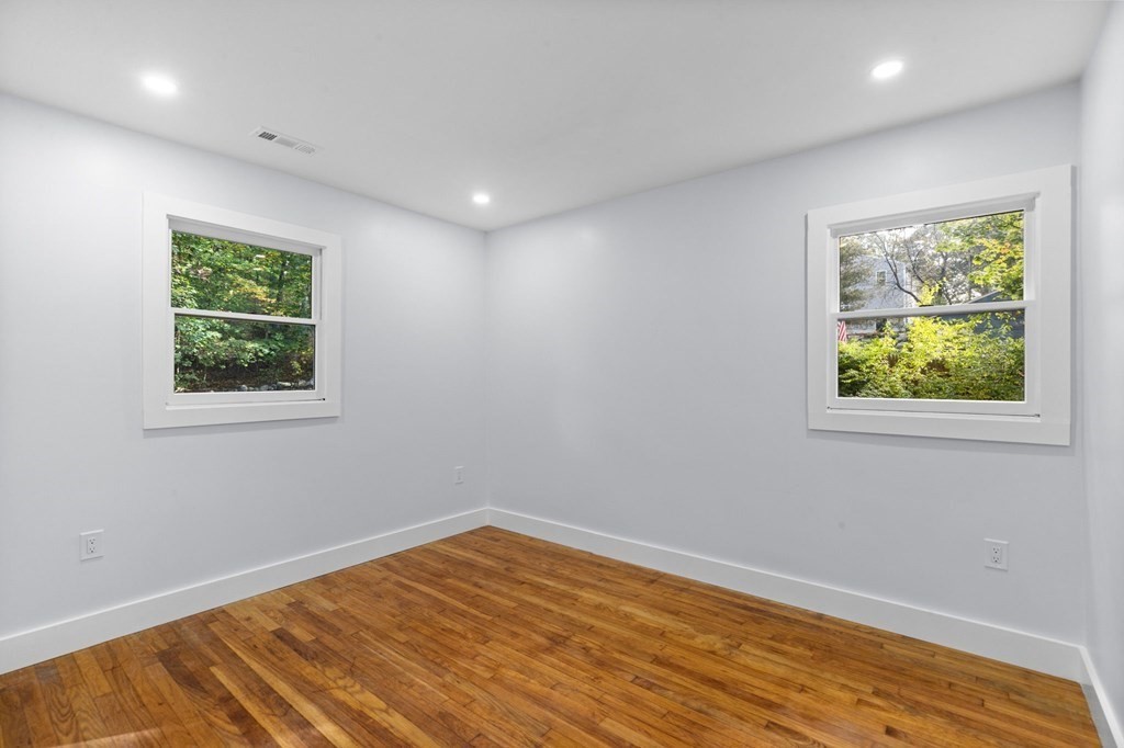 256 Great Road Maynard, MA 01754 - Photo 16 of 26 a view of empty room with wooden floor and fan
