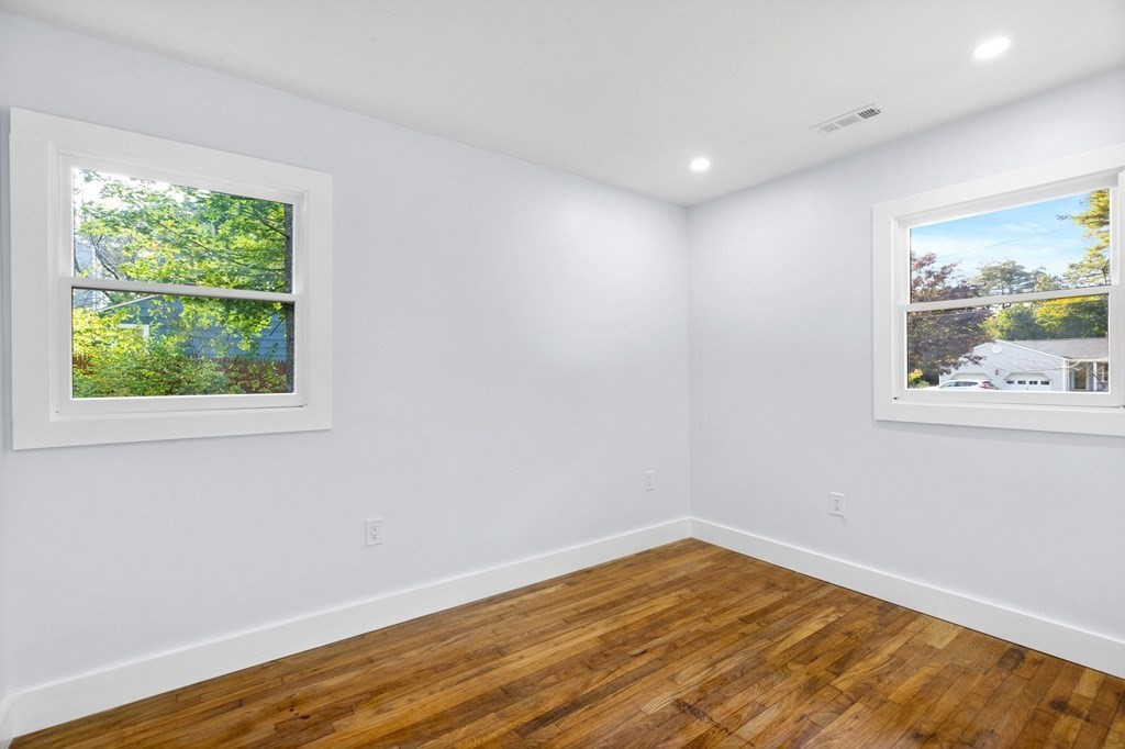 256 Great Road Maynard, MA 01754 - Photo 18 of 26 a view of empty room with wooden floor and fan