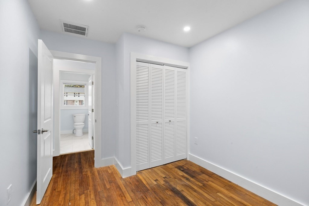 256 Great Road Maynard, MA 01754 - Photo 21 of 26 a view of a room with wooden floor and a bathroom