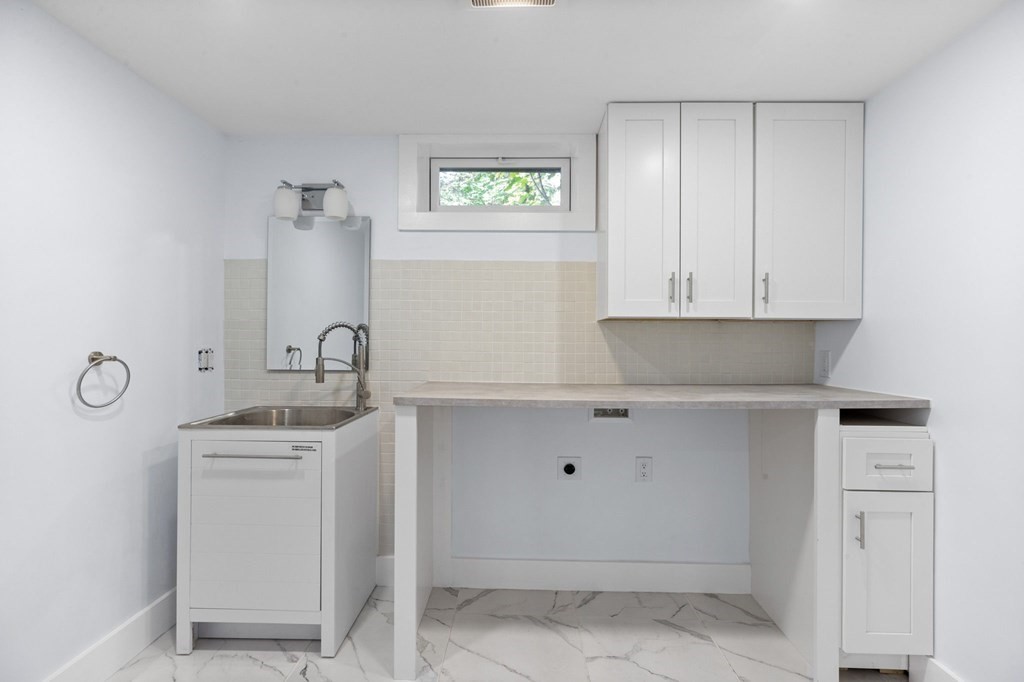 256 Great Road Maynard, MA 01754 - Photo 24 of 26 a kitchen with a sink and cabinets