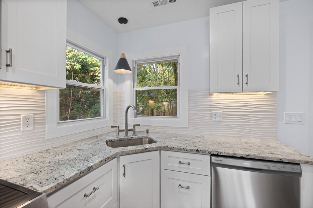 256 Great Road Maynard, MA 01754 - Photo 7 of 26 a kitchen with granite countertop a sink and a window