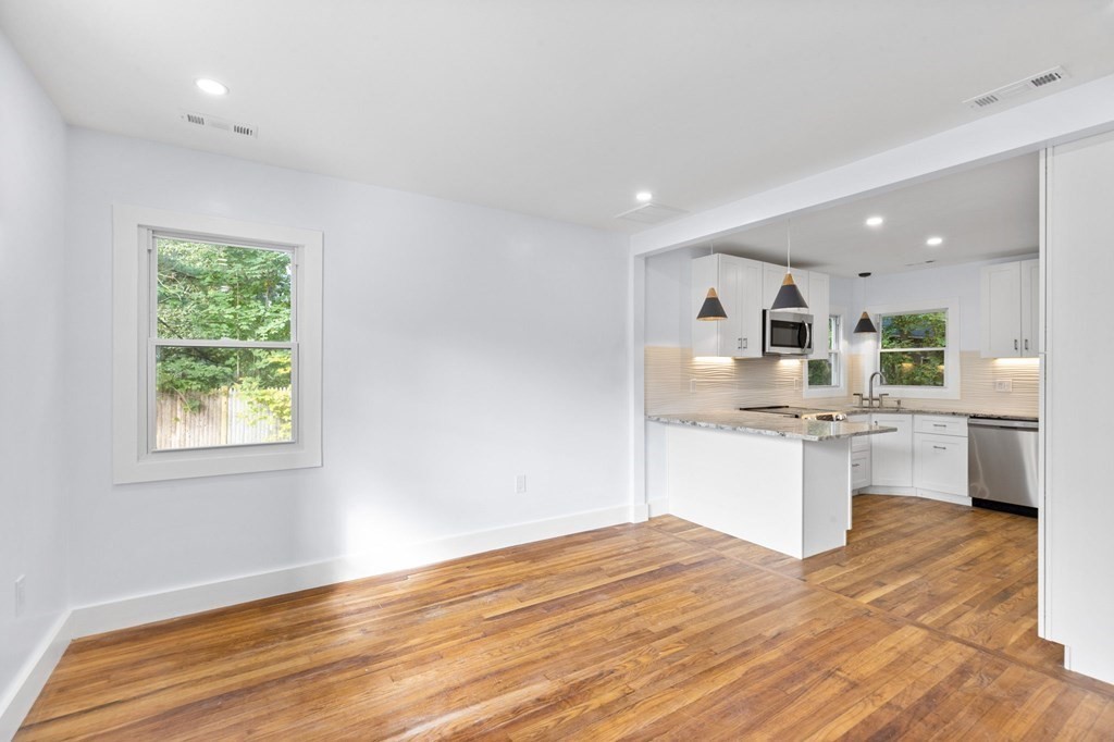 256 Great Road Maynard, MA 01754 - Photo 10 of 26 a kitchen with a refrigerator sink and cabinets