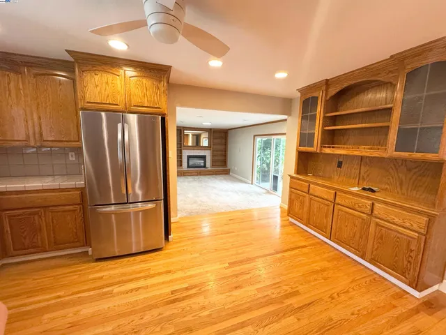 a kitchen with stainless steel appliances granite countertop a refrigerator and a sink