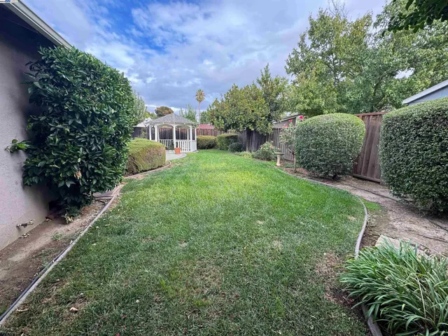 a view of a house with a yard and a garden