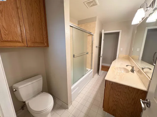 a bathroom with a toilet sink and vanity