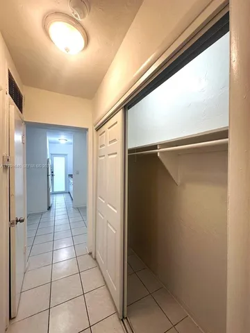a view of an empty room and wooden floor
