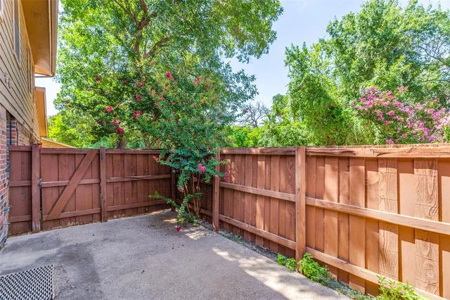 a view of a backyard with wooden fence