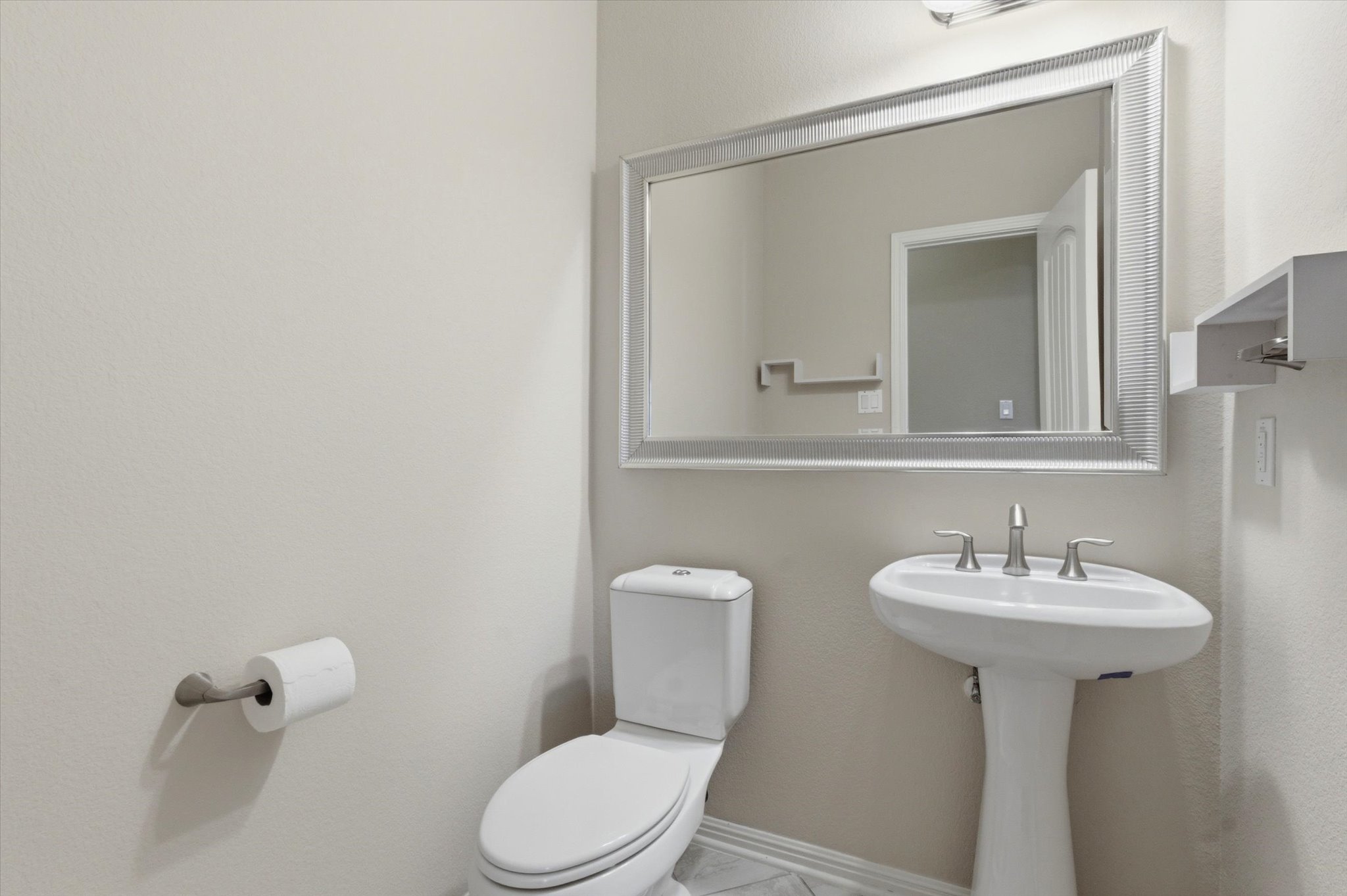 1511 Rimstone Drive Cedar Park, TX 78613 - Photo 17 of 39 A well-appointed half bath with new paint features a modern pedestal sink and elegant mirror.