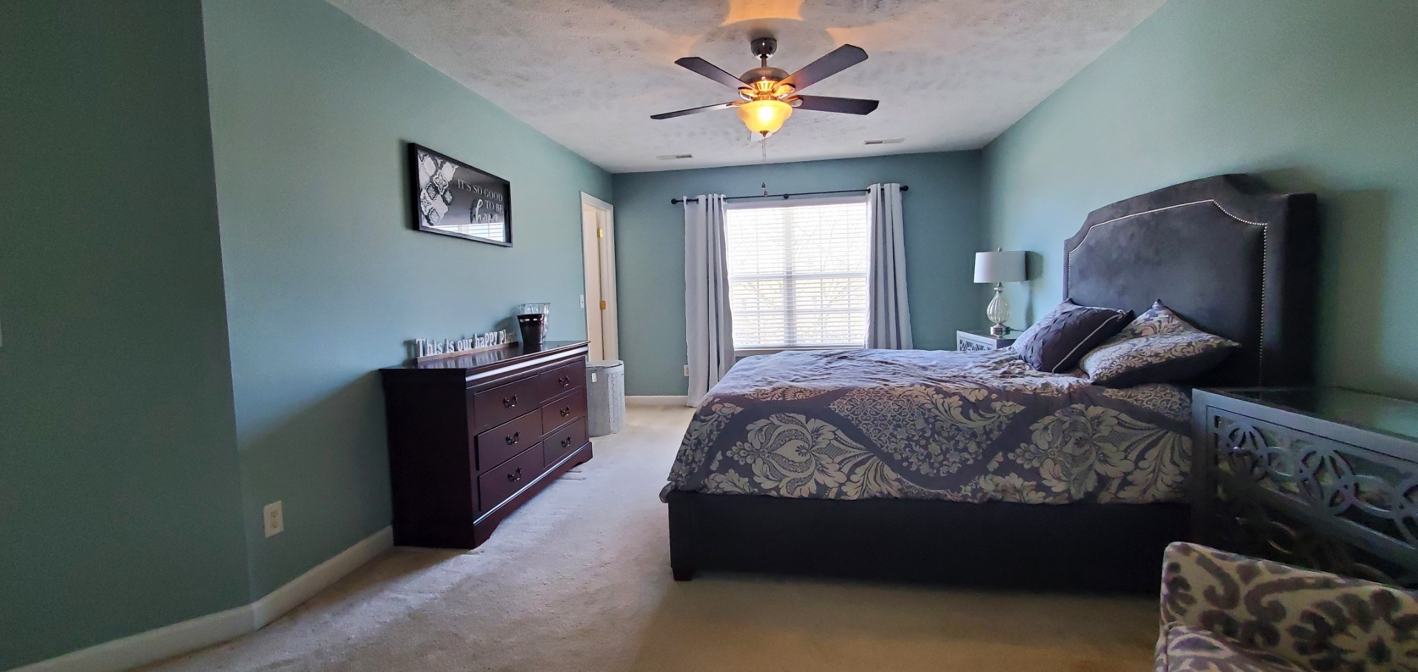 8008 Streamside Drive Mount Juliet, TN 37122 - Photo 12 of 35 a bedroom with a bed and a chandelier