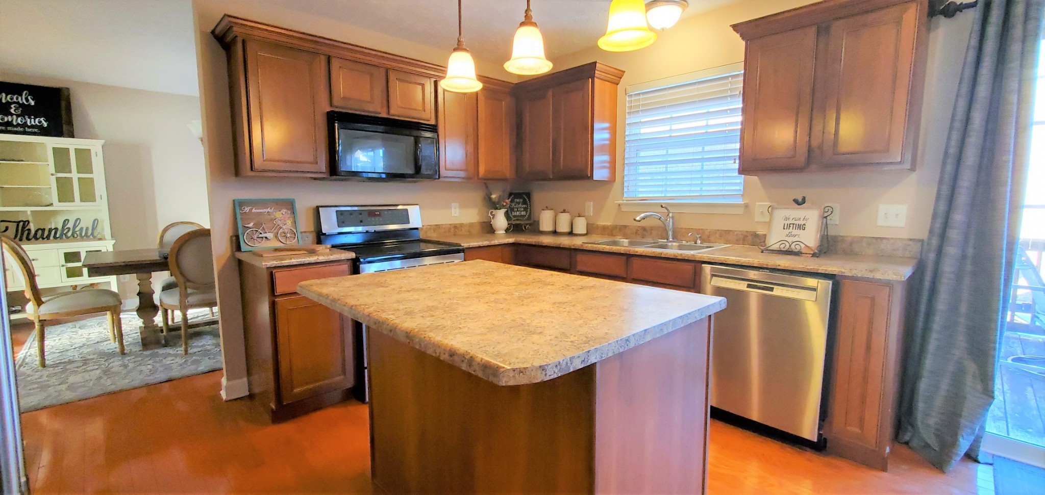 8008 Streamside Drive Mount Juliet, TN 37122 - Photo 6 of 35 a kitchen with stainless steel appliances granite countertop a sink a microwave cabinets and a dining table