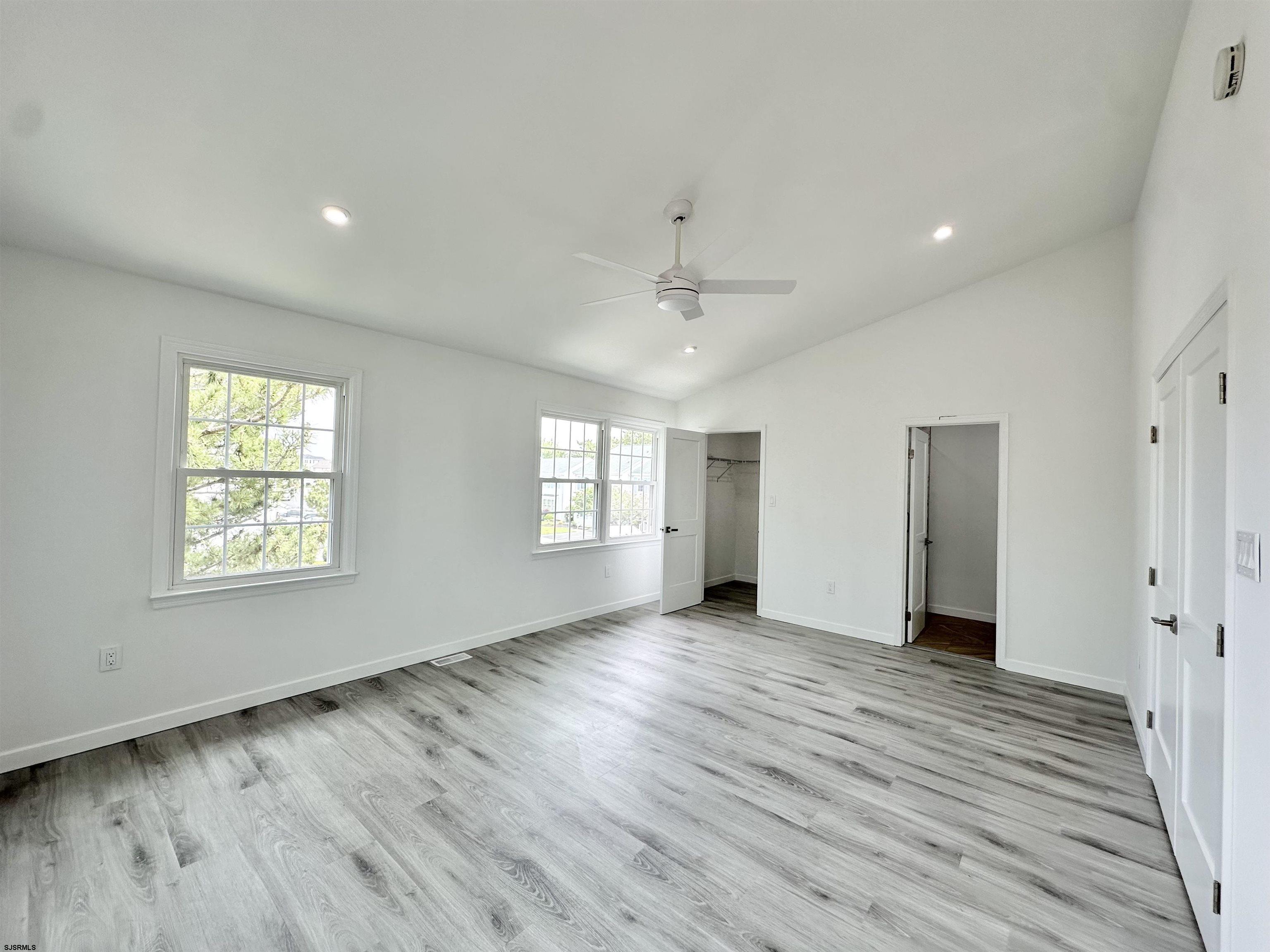 340 Seashell Lane Brigantine, NJ 08203 - Photo 12 of 47 an empty room with wooden floor and windows