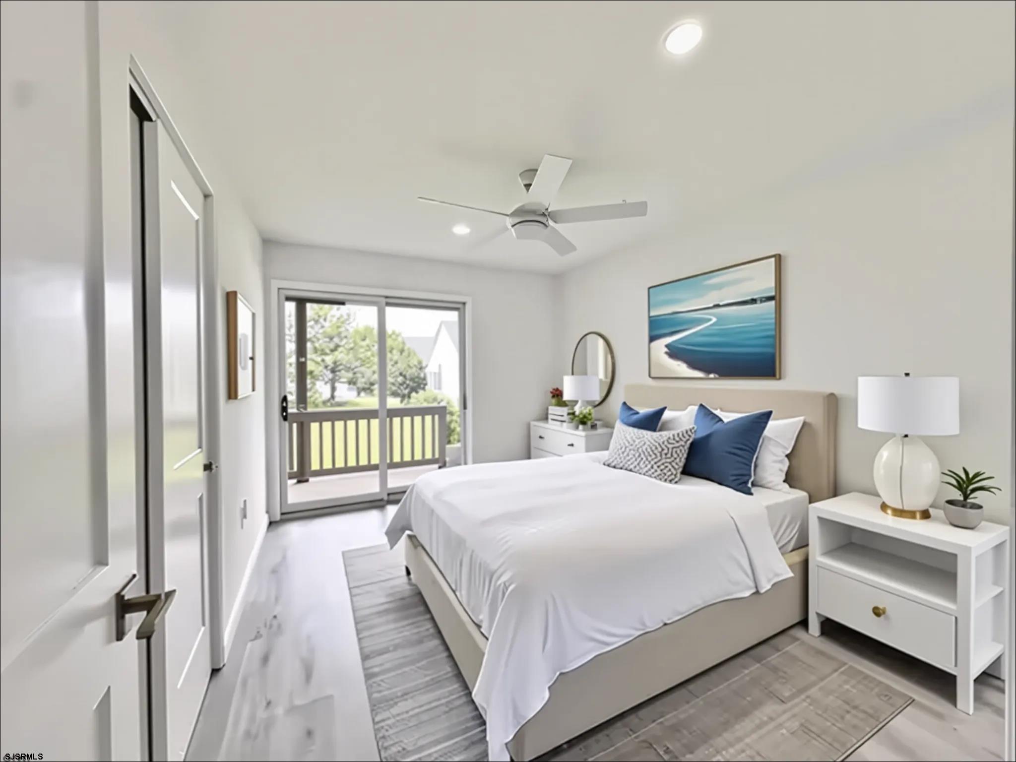 340 Seashell Lane Brigantine, NJ 08203 - Photo 20 of 47 a bedroom with a large bed and a chandelier fan