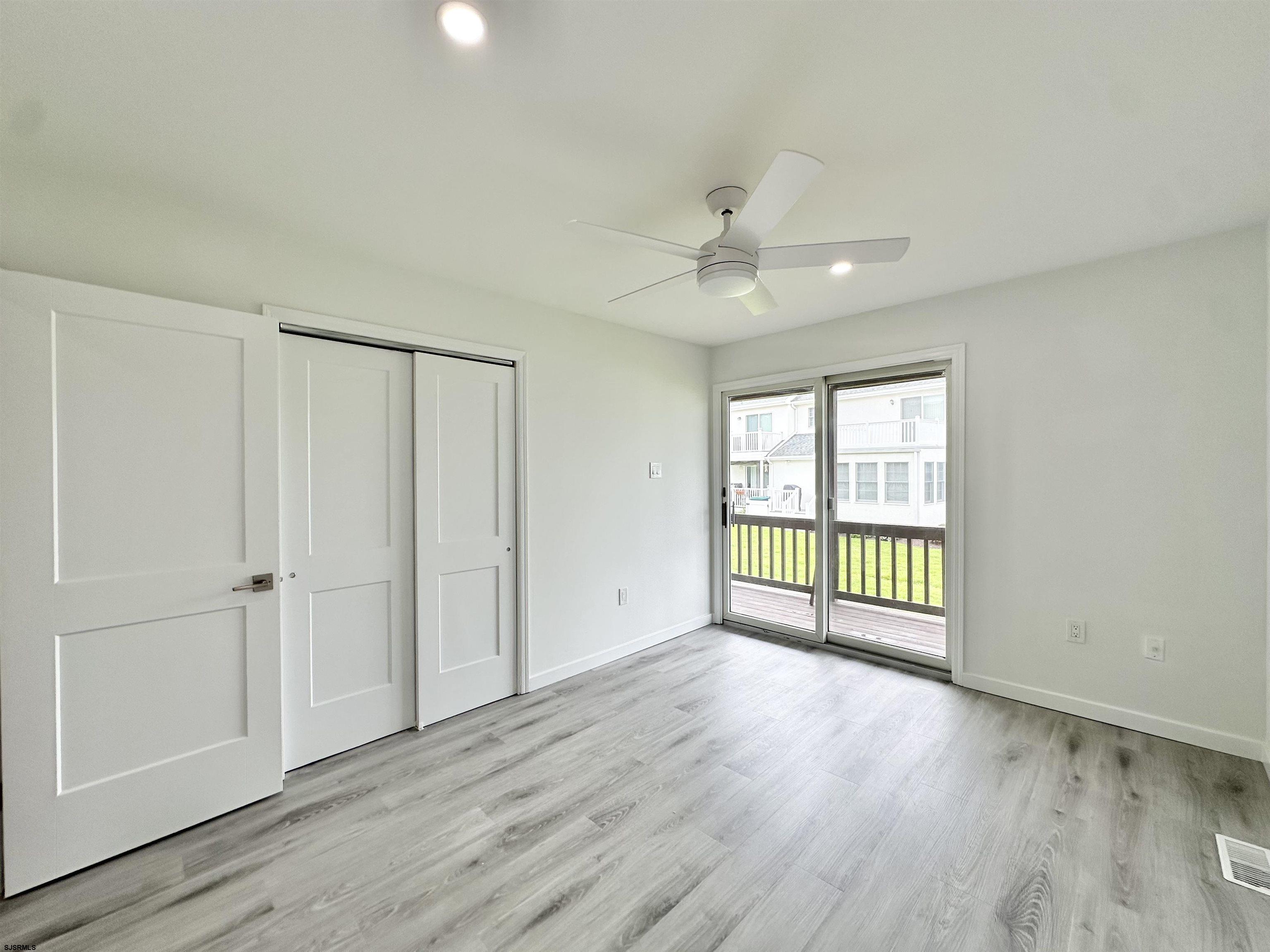 340 Seashell Lane Brigantine, NJ 08203 - Photo 22 of 47 a view of an empty room with a window and wooden floor