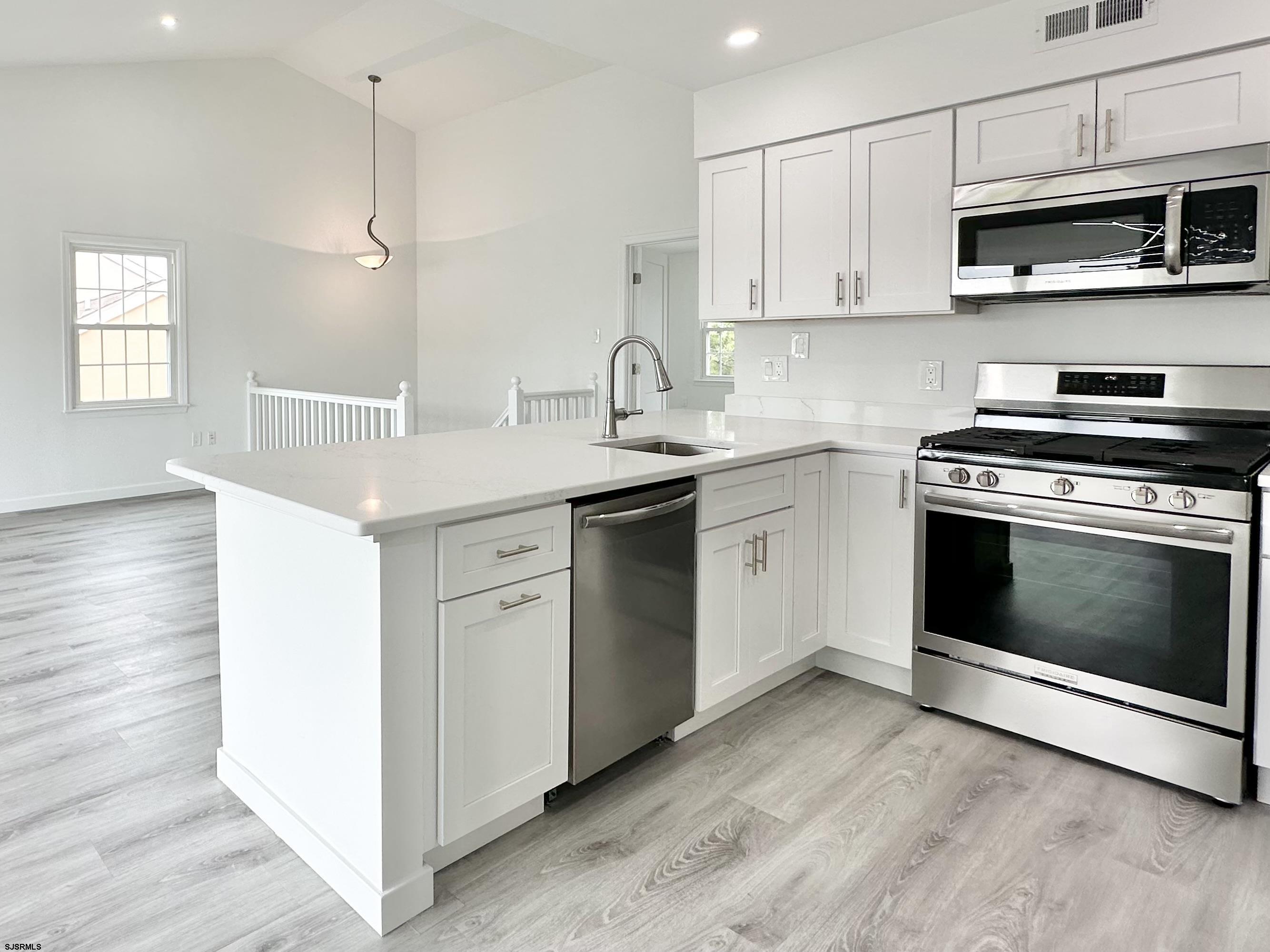 340 Seashell Lane Brigantine, NJ 08203 - Photo 47 of 47 a kitchen with stainless steel appliances granite countertop a sink and a stove