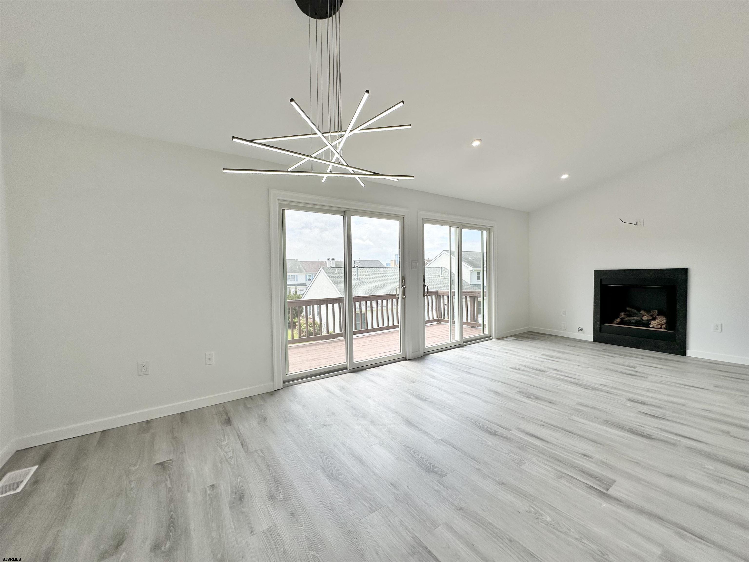 340 Seashell Lane Brigantine, NJ 08203 - Photo 7 of 47 a view of an empty room with a window and wooden floor