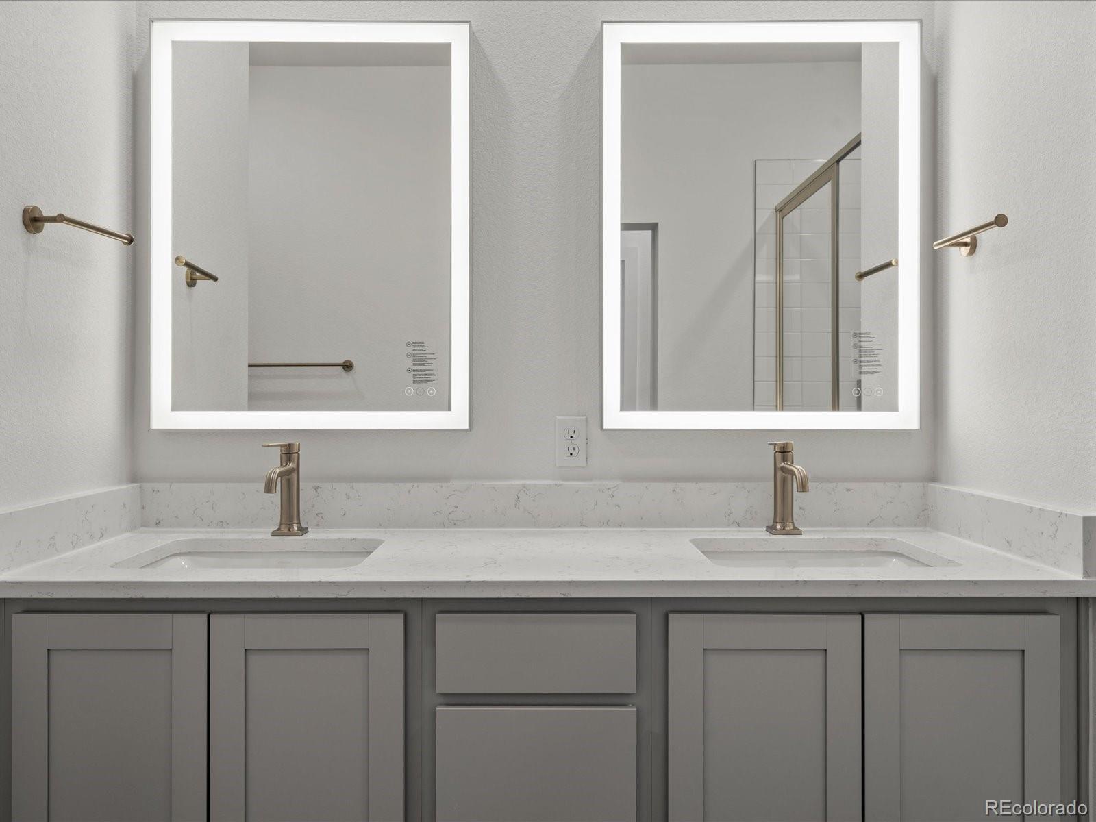 6153 North Ceylon Street, Unit 304 Denver, CO 80249 - Photo 14 of 24 a bathroom with double sink and a mirror