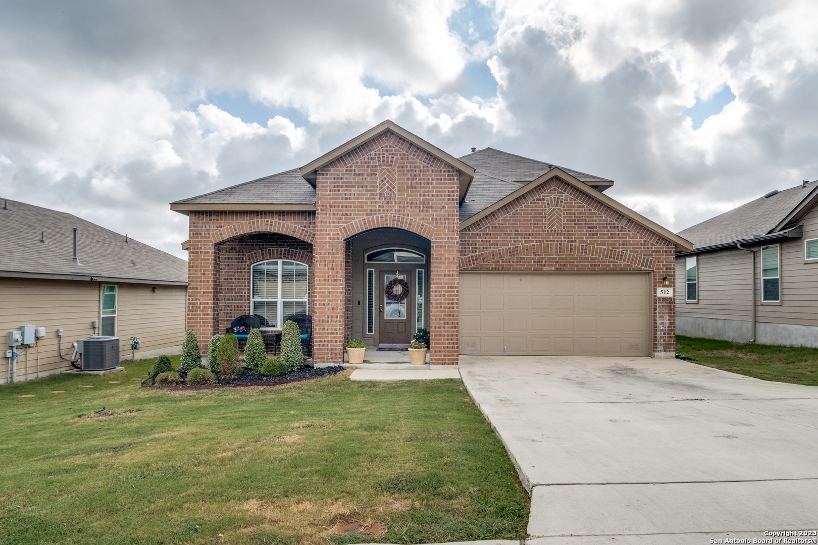 a front view of a house with garden