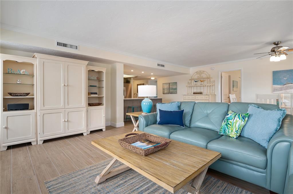 5963 Midnight Pass Road, Unit 332 Sarasota, FL 34242 - Photo 11 of 49 a living room with furniture and wooden floor