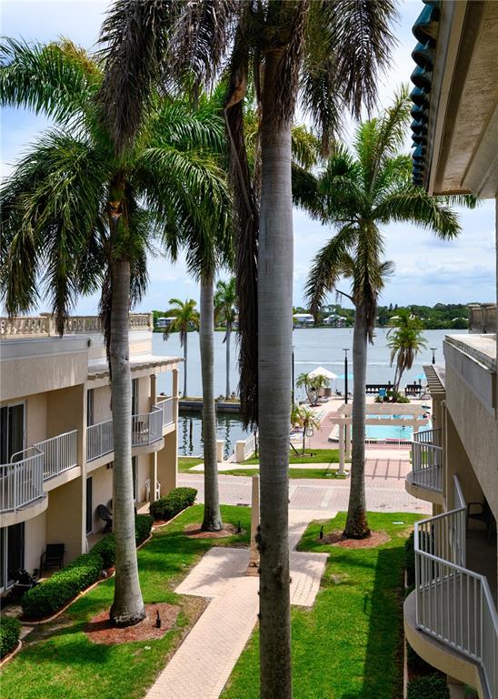 5963 Midnight Pass Road, Unit 332 Sarasota, FL 34242 - Photo 25 of 49 a front view of a house with a garden and tree