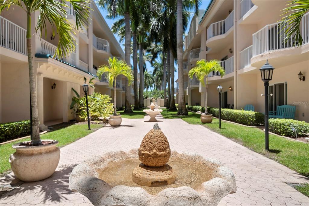 5963 Midnight Pass Road, Unit 332 Sarasota, FL 34242 - Photo 27 of 49 a view of a fountain in front of a building
