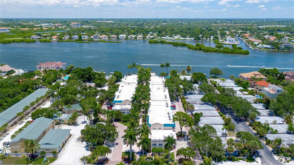 5963 Midnight Pass Road, Unit 332 Sarasota, FL 34242 - Photo 36 of 49 an aerial view of lake and residential houses with outdoor space